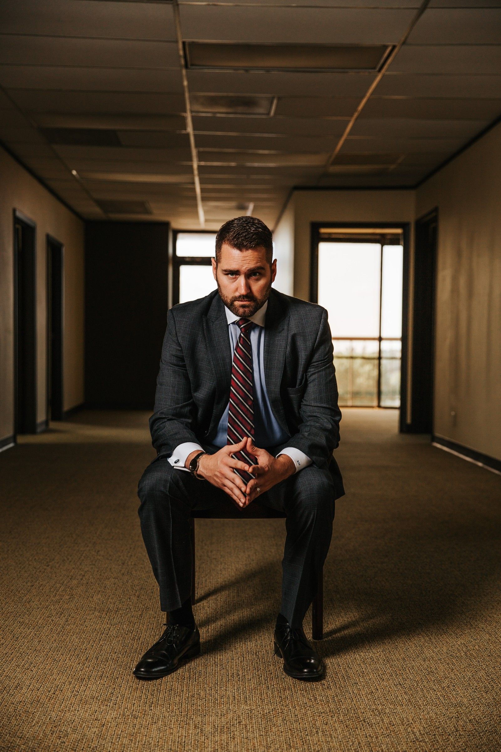 Brandon J. Grable, civil rights attorney in San Antonio, seated facing the camera with hands clasped