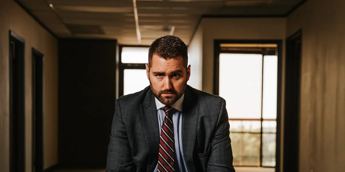 Brandon J. Grable, civil rights attorney in San Antonio, seated facing the camera with hands clasped